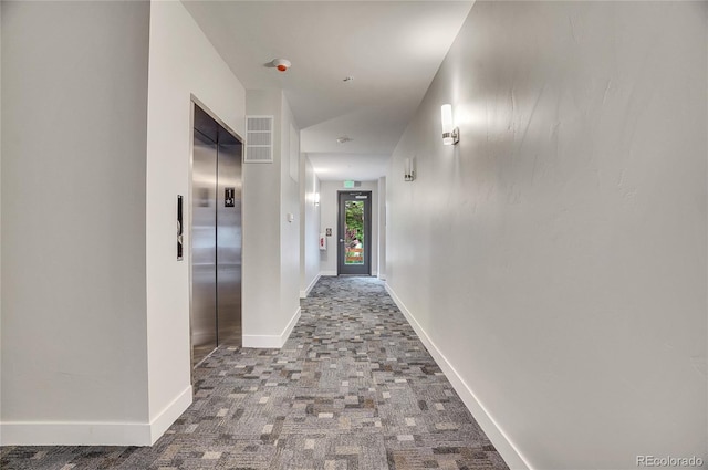 hall featuring carpet floors and elevator