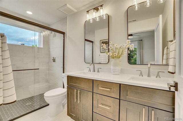 bathroom featuring an enclosed shower, vanity, toilet, and tile patterned flooring