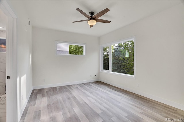 spare room with light hardwood / wood-style floors and ceiling fan