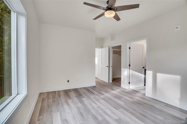 empty room featuring ceiling fan and light hardwood / wood-style flooring