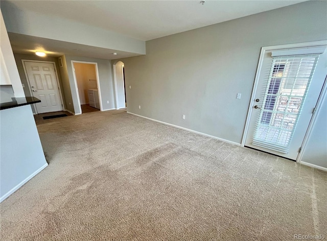 unfurnished living room with light carpet