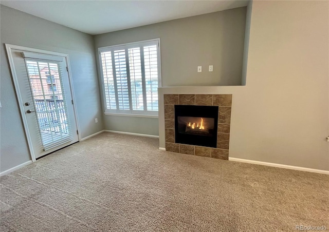 unfurnished living room with a fireplace and carpet floors