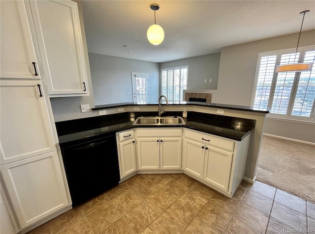 kitchen featuring black dishwasher, sink, white cabinets, and decorative light fixtures