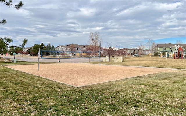 view of community with a yard, volleyball court, and a playground