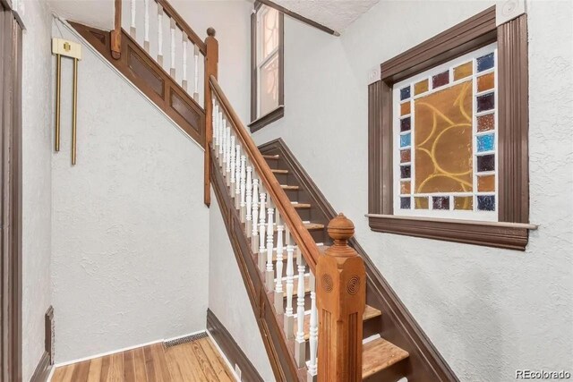 2227 N Gilpin St, Denver, CO 80205 - stairs with baseboards, a textured wall, and wood finished floors