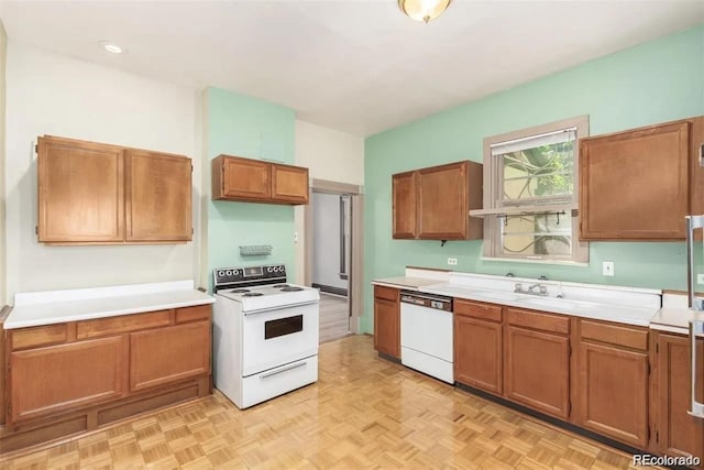 kitchen with light countertops, a sink, brown cabinets, and white appliances