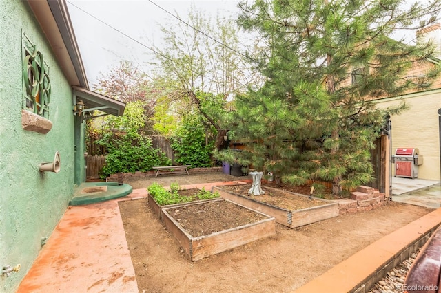 view of yard featuring a garden and fence