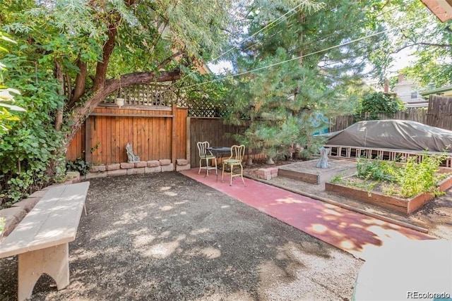exterior space featuring a fenced backyard, a garden, and a patio area