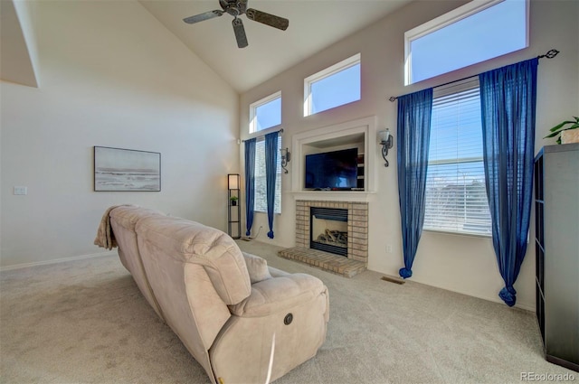 carpeted living room featuring visible vents, high vaulted ceiling, a brick fireplace, and a ceiling fan