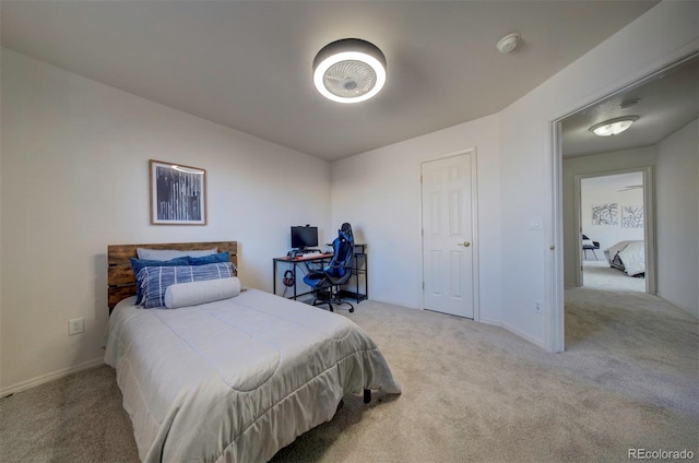 bedroom featuring baseboards and carpet