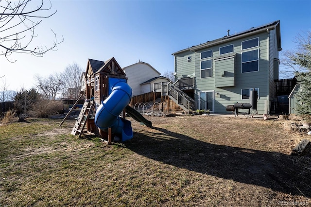 rear view of property featuring a playground