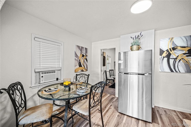 1209 E Routt Ave, Pueblo, CO 81004 - dining area featuring light wood-style floors and cooling unit