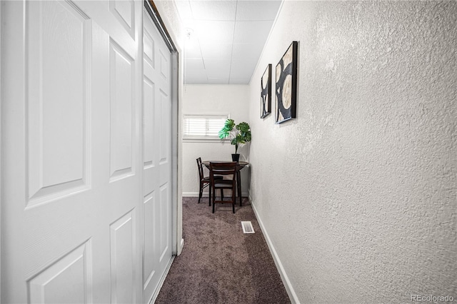 1209 E Routt Ave, Pueblo, CO 81004 - hall featuring a textured wall and dark colored carpet