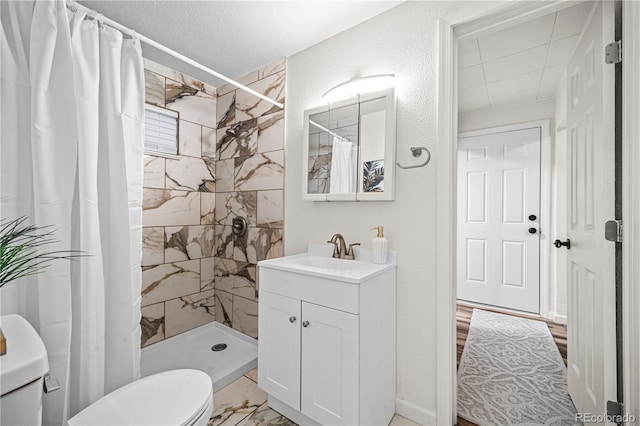 1209 E Routt Ave, Pueblo, CO 81004 - bathroom with vanity, a tile shower, and marble look tile flooring