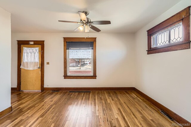 spare room with light wood-type flooring, baseboards, and visible vents