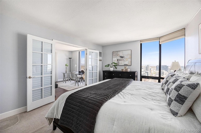 1625 Larimer St Unit 2601, Denver, CO 80202 - bedroom with a textured ceiling, french doors, and carpet floors
