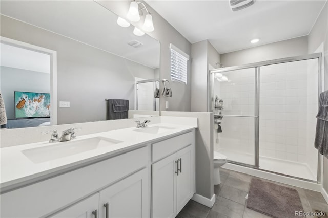 bathroom with tile patterned flooring, vanity, an enclosed shower, and toilet