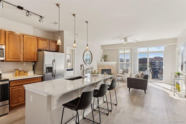 kitchen featuring a kitchen island with sink, a breakfast bar area, and stainless steel appliances