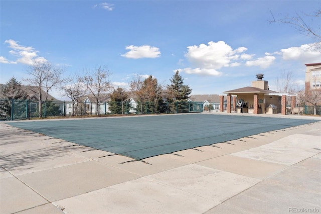 pool with fence and a patio