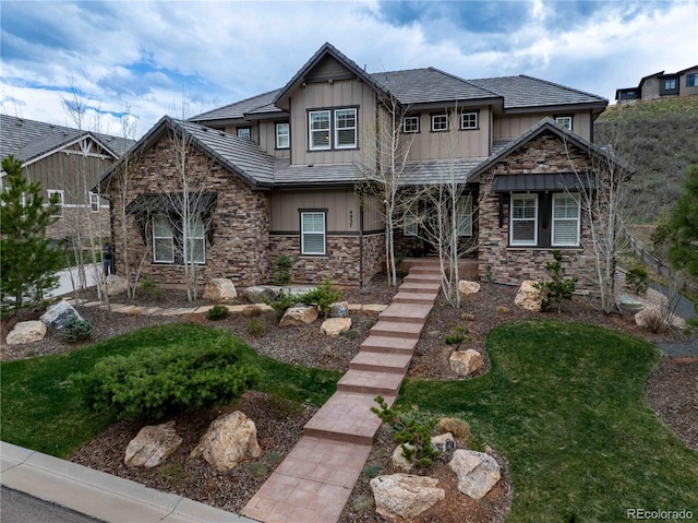 4937 Hogback Ridge Rd, Morrison, CO 80465 - craftsman inspired home featuring board and batten siding, stone siding, and a front lawn