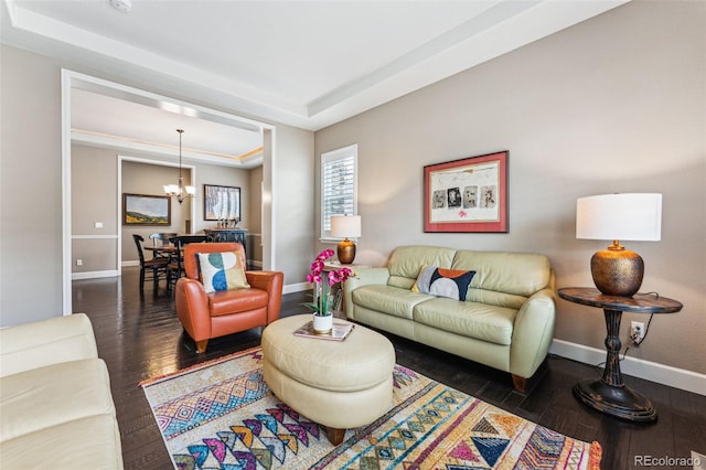 4937 Hogback Ridge Rd, Morrison, CO 80465 - living room featuring a tray ceiling, a chandelier, wood-type flooring, and baseboards