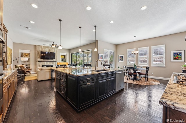 4937 Hogback Ridge Rd, Morrison, CO 80465 - kitchen with a sink, ceiling fan with notable chandelier, stainless steel appliances, baseboards, and dark cabinets