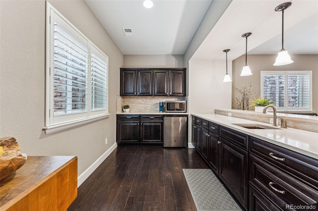4937 Hogback Ridge Rd, Morrison, CO 80465 - kitchen featuring light countertops, visible vents, a sink, baseboards, and appliances with stainless steel finishes