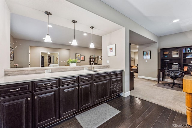 4937 Hogback Ridge Rd, Morrison, CO 80465 - kitchen with baseboards, a peninsula, dark wood-style flooring, and light countertops