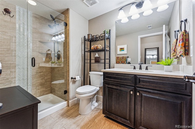 4937 Hogback Ridge Rd, Morrison, CO 80465 - full bath with vanity, visible vents, a shower stall, and toilet