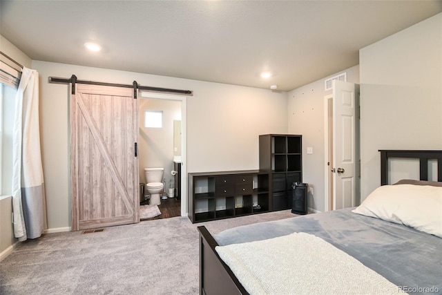 213 S Old Hammer Ct, Aurora, CO 80018 - bedroom featuring a barn door, connected bathroom, carpet, and recessed lighting
