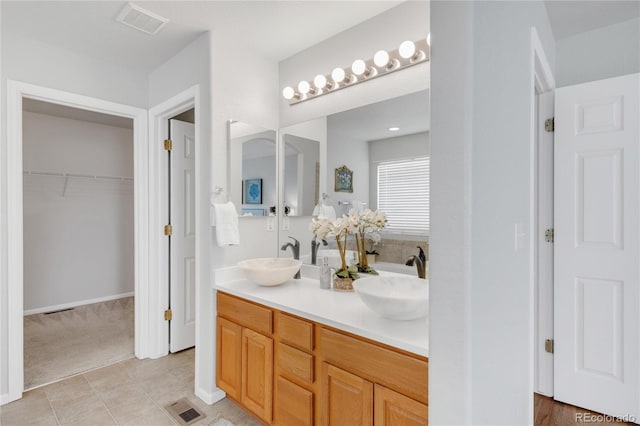 23612 E Mississippi Cir, Aurora, CO 80018 - full bath featuring double vanity, a spacious closet, and tile patterned flooring