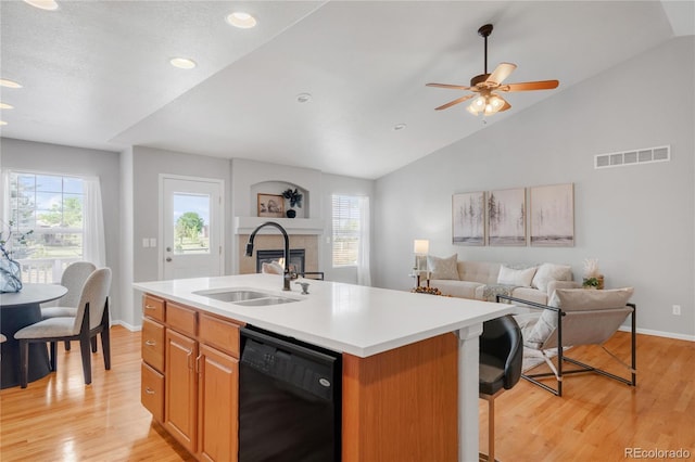 23612 E Mississippi Cir, Aurora, CO 80018 - kitchen with dishwasher, plenty of natural light, lofted ceiling, a kitchen island with sink, and open floor plan