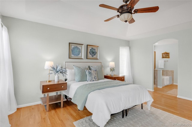 23612 E Mississippi Cir, Aurora, CO 80018 - bedroom featuring wood finished floors, arched walkways, and a ceiling fan