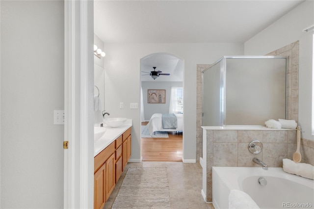 23612 E Mississippi Cir, Aurora, CO 80018 - ensuite bathroom featuring double vanity, a garden tub, a shower stall, and a ceiling fan