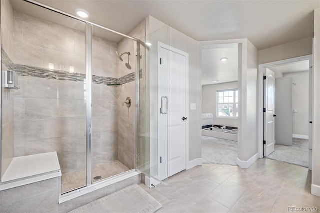 bathroom featuring tile patterned flooring and a shower with shower door