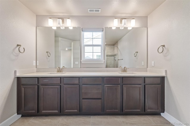 bathroom with vanity, tile patterned floors, and a shower with shower door