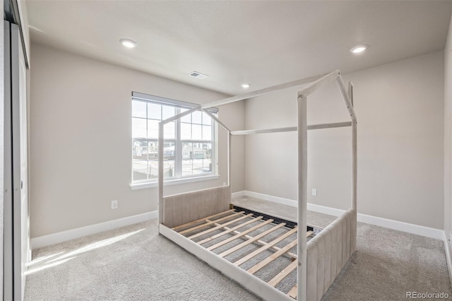 unfurnished bedroom with light carpet