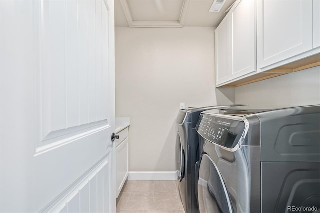 laundry area with cabinets, washer and dryer, and light tile patterned flooring