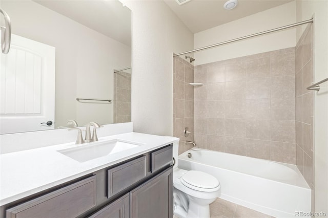 full bathroom with vanity, tile patterned flooring, tiled shower / bath combo, and toilet