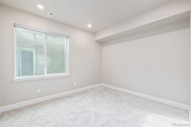 unfurnished room featuring a healthy amount of sunlight and light carpet