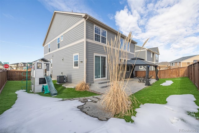 rear view of house with a gazebo, central AC unit, a yard, a playground, and a patio