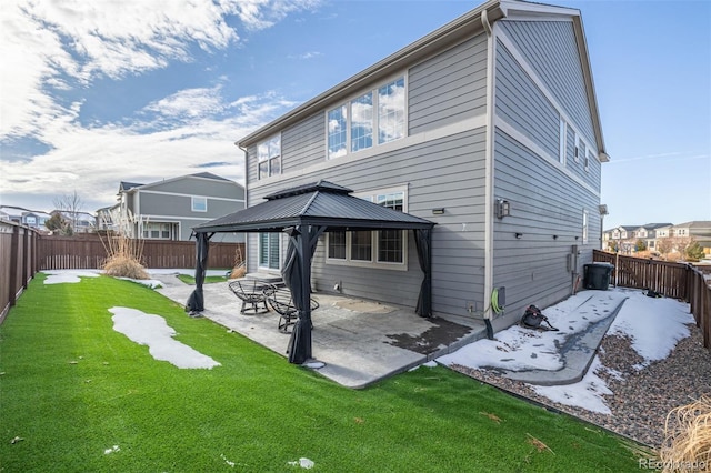 rear view of house with a gazebo, a patio area, and a lawn