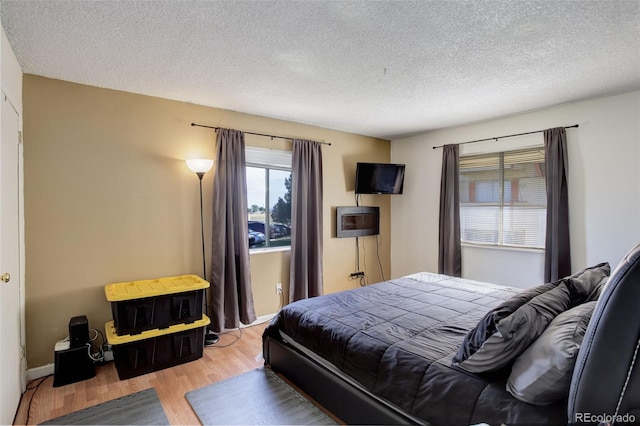 bedroom featuring a textured ceiling and light wood-type flooring