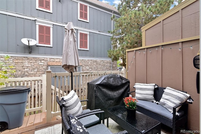 view of patio / terrace with a deck and a grill