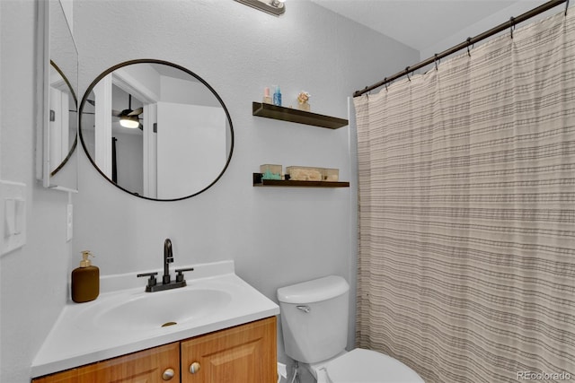 bathroom with vanity, toilet, and ceiling fan