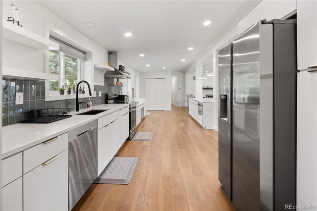 2175 S Joliet St, Aurora, CO 80014 - kitchen featuring appliances with stainless steel finishes, open shelves, modern cabinets, white cabinetry, and wall chimney exhaust hood