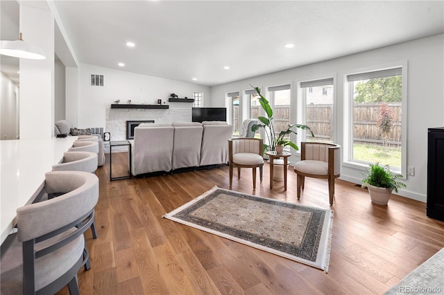 2175 S Joliet St, Aurora, CO 80014 - living area featuring wood finished floors, a fireplace, recessed lighting, and lofted ceiling