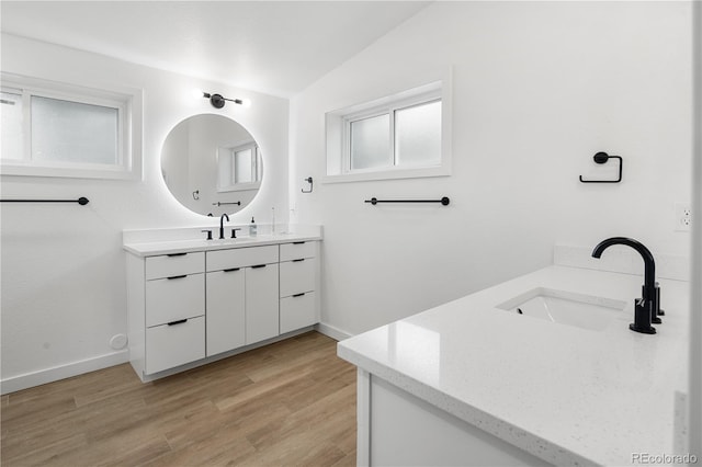 2175 S Joliet St, Aurora, CO 80014 - full bath featuring vanity, lofted ceiling, and wood finished floors