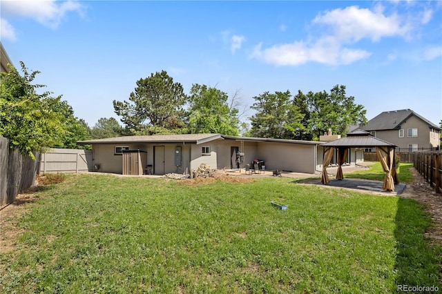 2175 S Joliet St, Aurora, CO 80014 - rear view of property with a gazebo, a patio, and a fenced backyard