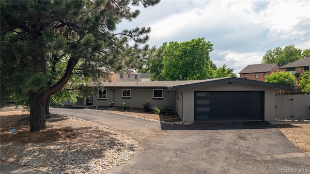 2175 S Joliet St, Aurora, CO 80014 - view of front facade featuring asphalt driveway and a garage